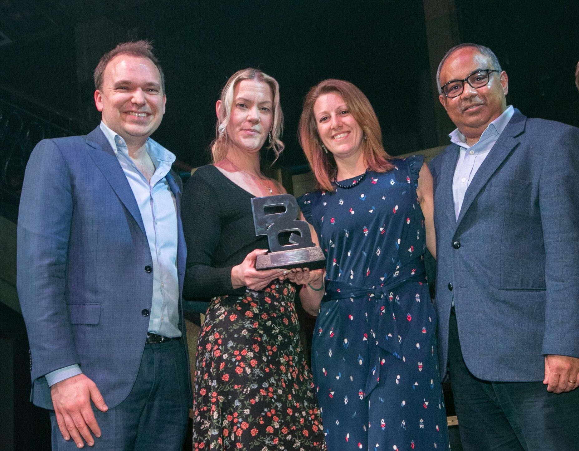 An image showing 5 professional individuals within the further education sector, holding an award, recognising Mindful Education's excellence in education.
