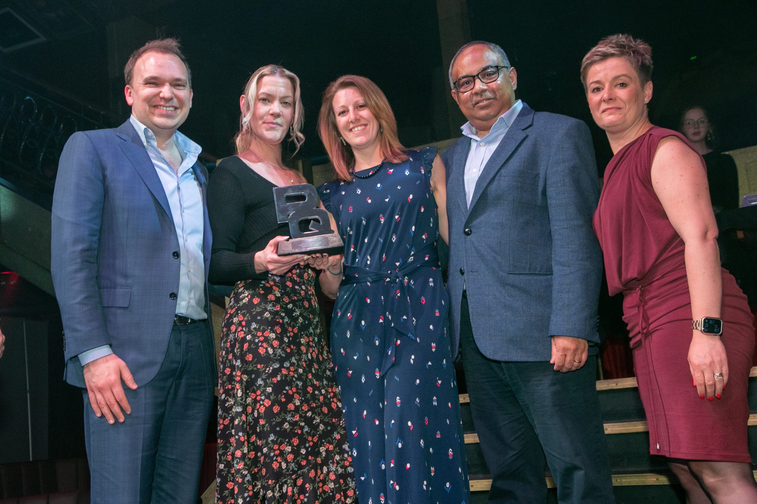 An image showing 5 professional individuals within the further education sector, holding an award, recognising Mindful Education's excellence in education.