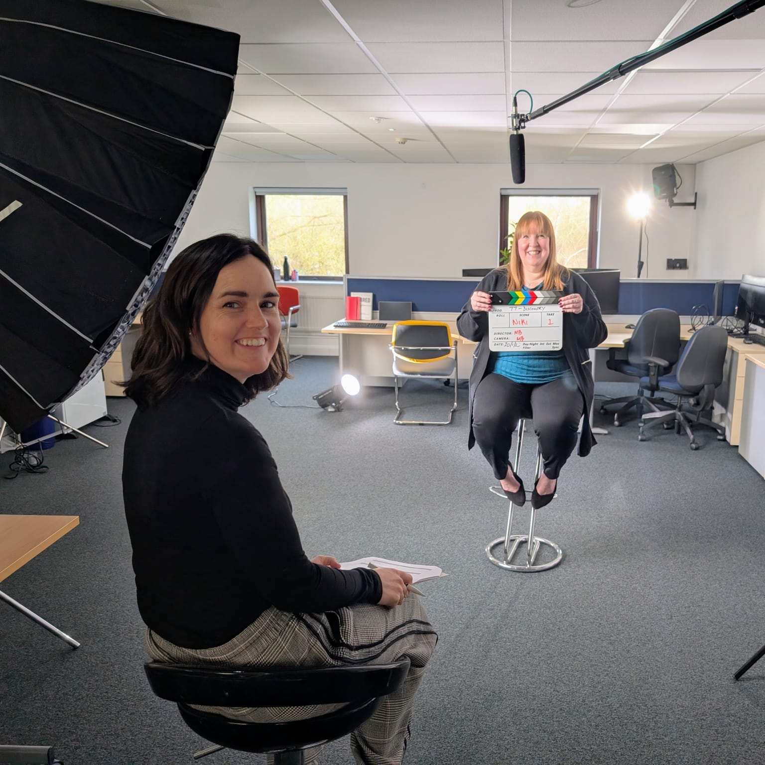 Two professionals in further education sitting down and preparing to film a case study about Mindful Educations professional apprenticeships.