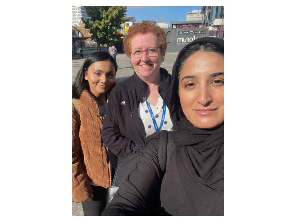 An image showing two Mindful Education employees with a marketing officer at a partnering college.