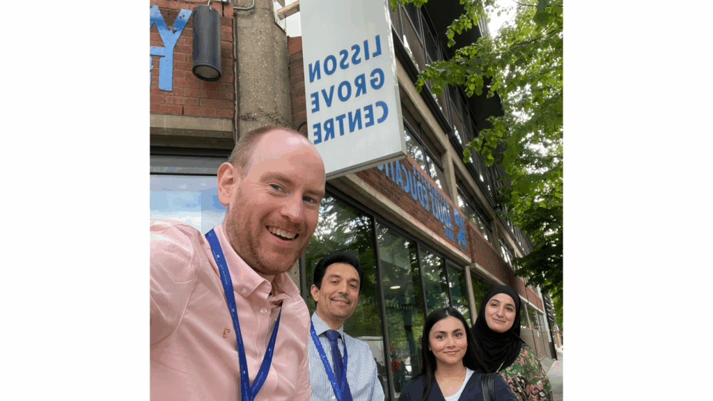 Two senior management individuals and two marketing individuals taking a selfie together.