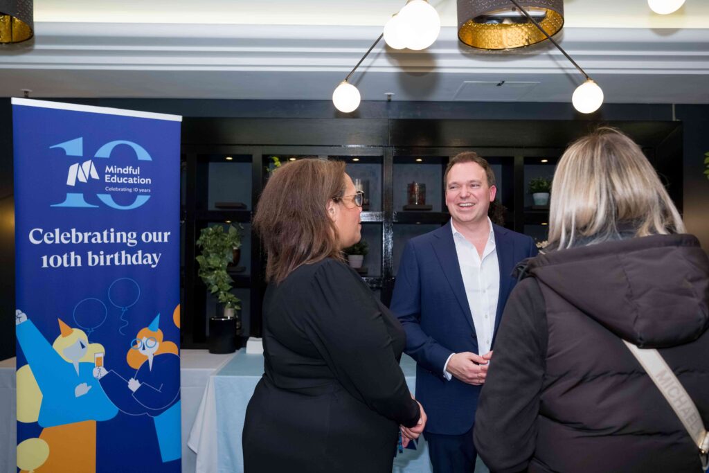 An image of Mindful Education's director, speaking with guests at the Mindful Education 10th anniversary drinks reception.