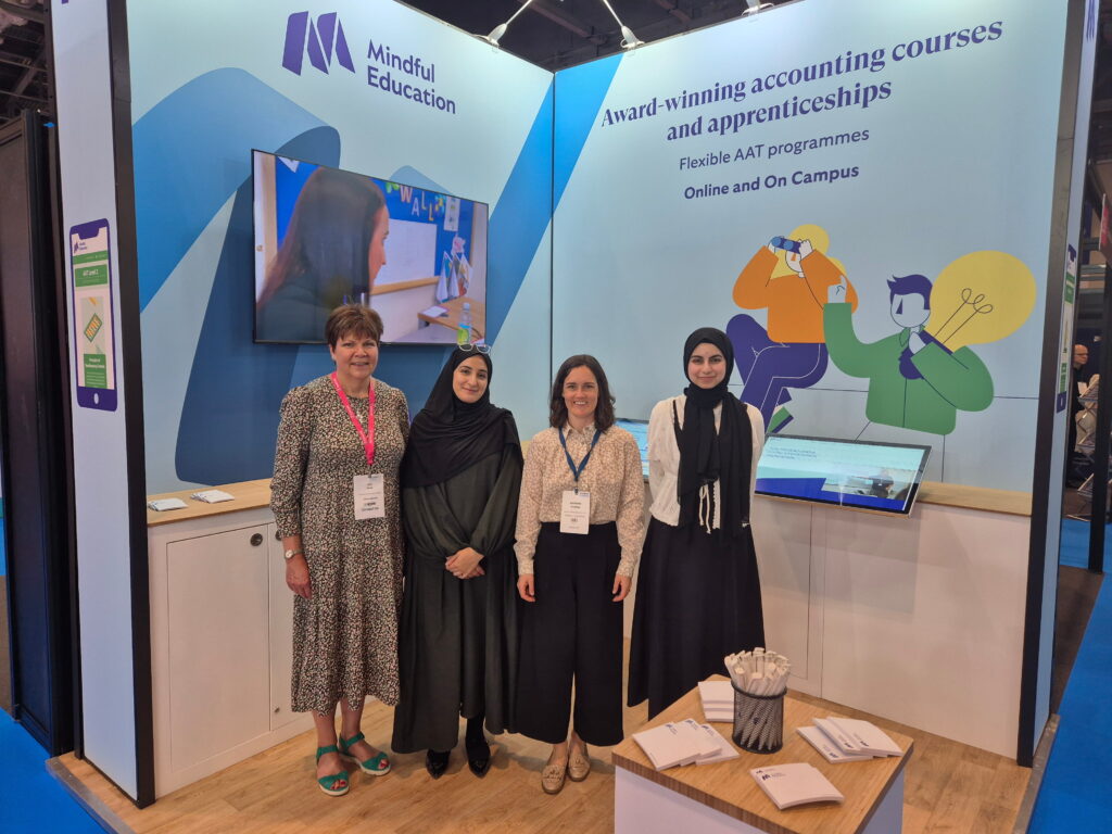 Four members of the Mindful Education team in front of their exhibition stand at Accountex London.