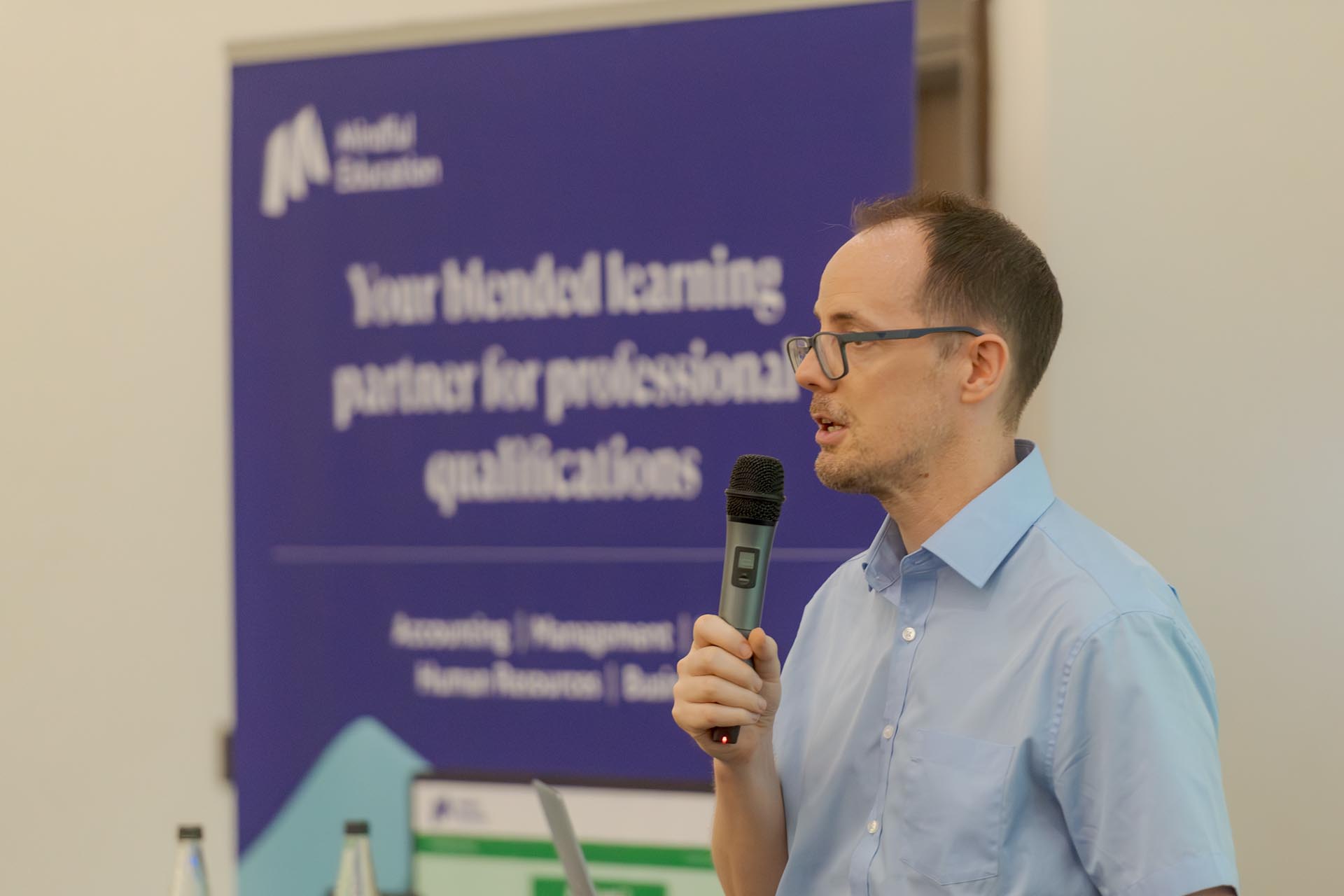 A professional within the employment sector presenting at a Mindful Education company conference.